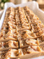 Close-up of a fresh batch of Eden Body Care Home for Fall handmade soap bars with sculpted tops and botanical accents, scented with evergreen, cinnamon, apple, and fresh linen.