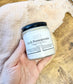 Eden Body Care Lush Pomegranate whipped body mousse jar held in hand against a soft neutral fabric background.