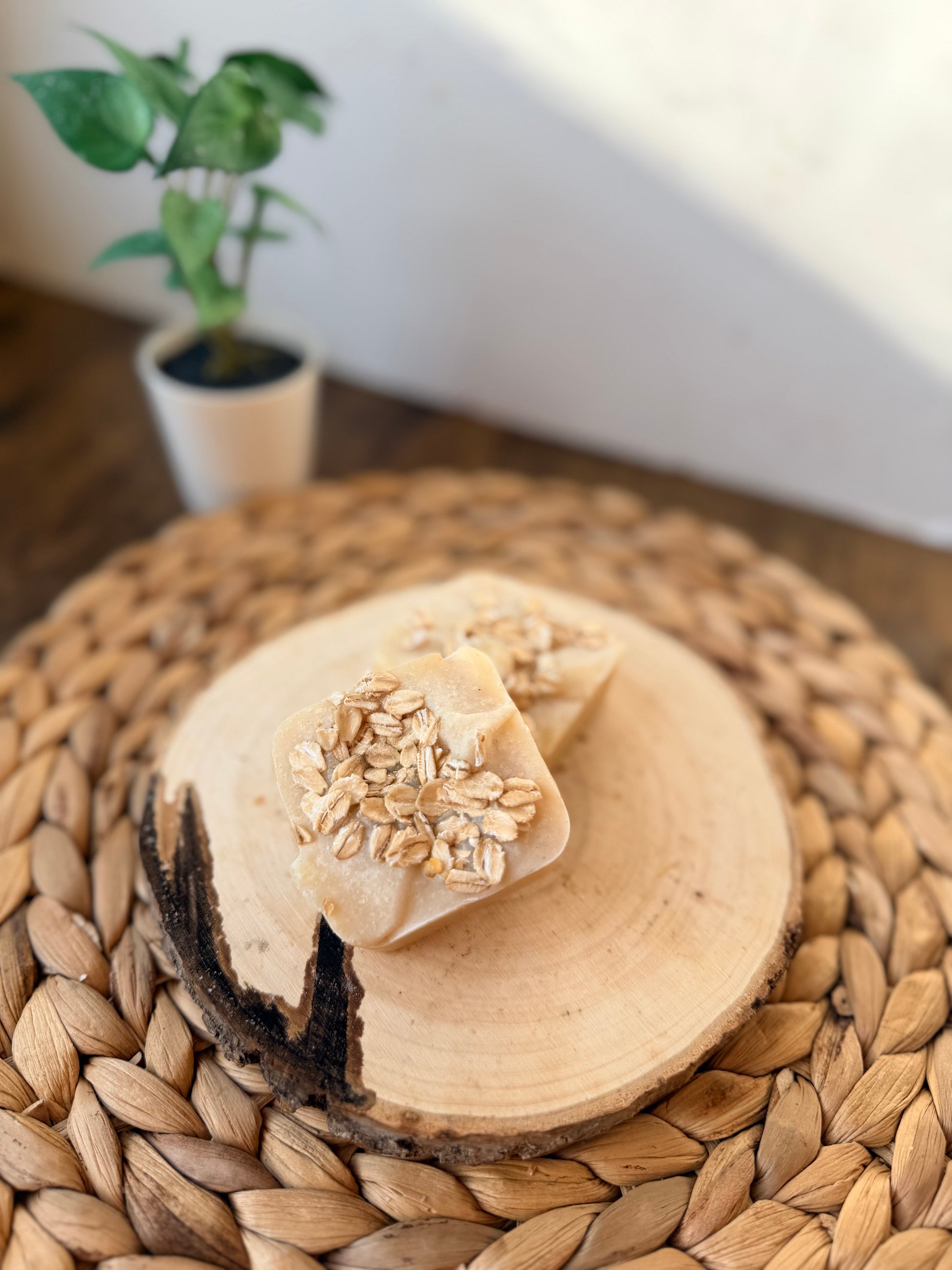 Mini handmade oatmeal and honey soap bars topped with rolled oats, sized for hand washing or gifting.