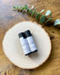 Two Eden Body Care lip balm tubes, Lemon Lavender and Lavender, displayed on a natural wood slice