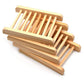 Natural light wood slatted soap dish rack designed to keep handmade soap bars elevated and dry between uses.