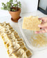 a stack of oatmeal and honey lined up with a bar picked up by hand to show size