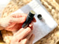 Open Eden Body Care peppermint lip balm tube held in hand, showing the natural balm inside.
