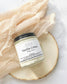 Eden Body Care Vanilla Crème body mousse jar displayed on a natural wood slice with soft neutral fabric in the background
